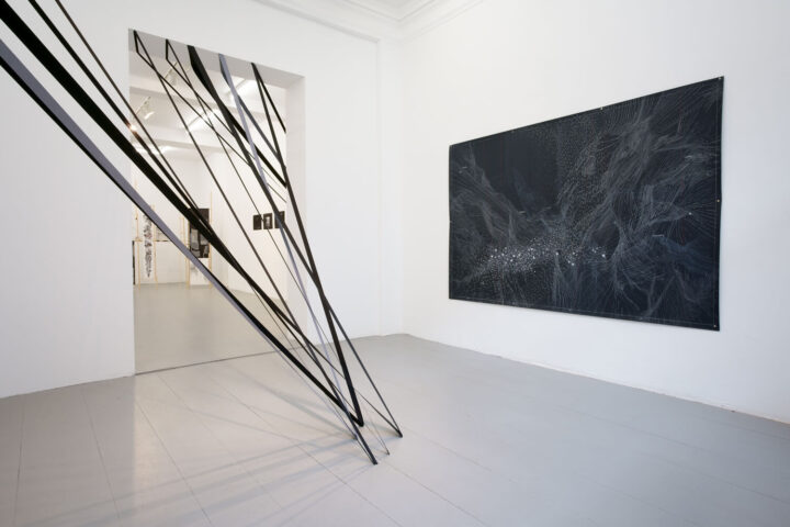 exhibition view frise gallery. drawing with a black type in the space and a black drawing