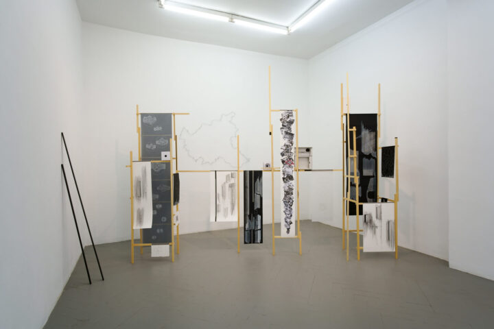exhibition view frise gallery. installation with a wooden structure and drawings